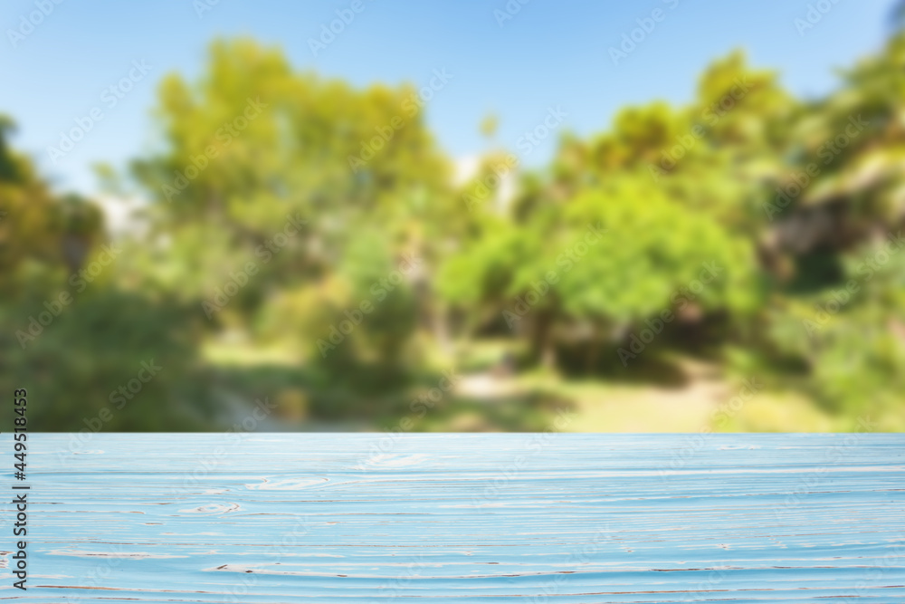 blue wood table top on blur trees and sky background blue wood table top on blur trees and sky background