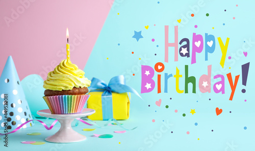 Happy Birthday! Delicious cupcake with burning candle on color background