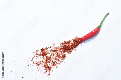 fresh red chili cutting and cayenne pepper spreading on white background