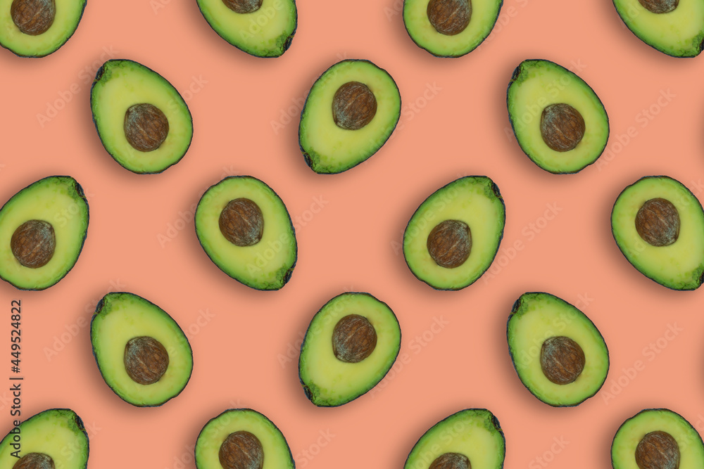 Fototapeta premium Tasty avocados pattern on pastel orange background