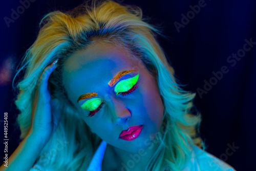 portrait of a woman with painted face, woman with uv makeup in studio, portrait of a woman in carnival mask, the woman is decorated in a ultraviolet powder