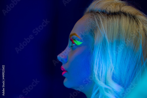 portrait of a woman with painted face, woman with uv makeup in studio, portrait of a woman in carnival mask, the woman is decorated in a ultraviolet powder