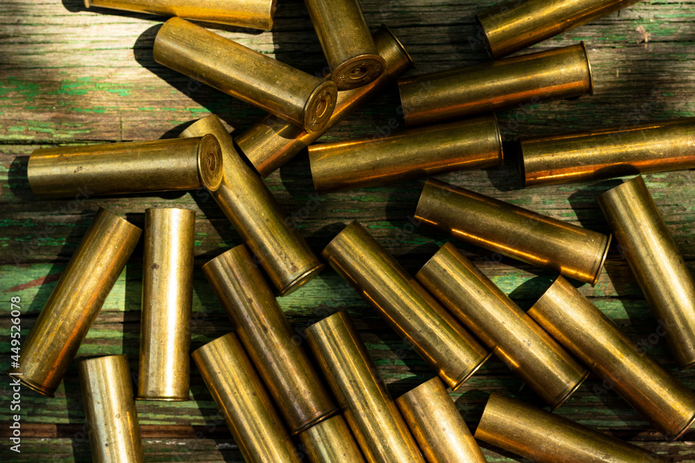 many cartridges from bullets on a wooden background many cartridges from bullets on a wooden background