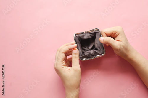  women hand open an empty wallet on pink background 