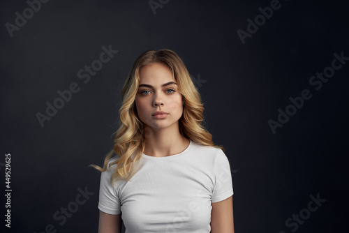 woman in white t-shirt fashion emotions studio dark background