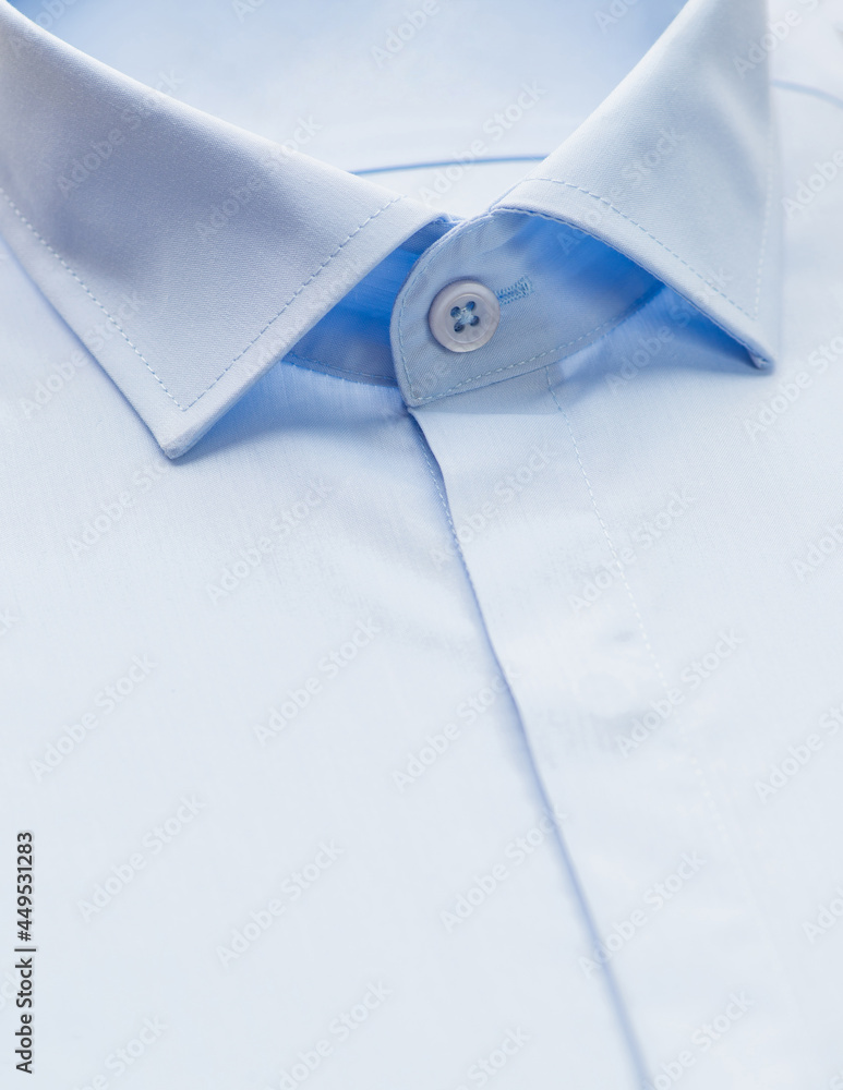 blue shirt with a focus on the collar and button, close-up blue shirt with a focus on the collar and button, close-up