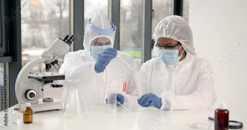 Researchers during andemic checking sample in biochemistry lab photo