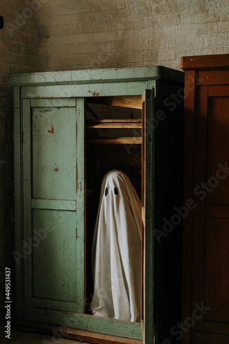 little ghost standing in the closet. Autumn halloween