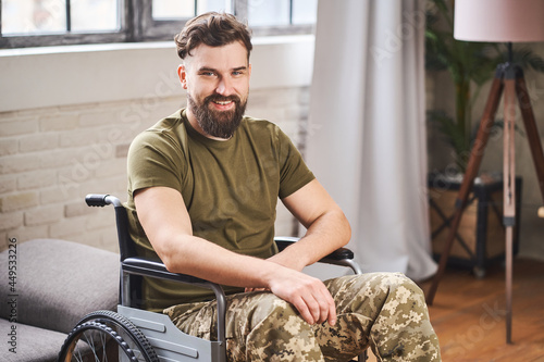 Disabled ex-serviceman wearing military uniform and sitting in a wheelchair