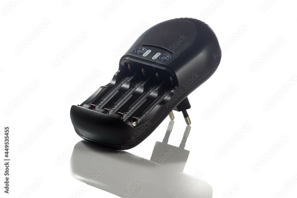 The charger for 4 AA and AAA size batteries is isolated on a white background. The charger for 4 AA and AAA size batteries is isolated on a white background.