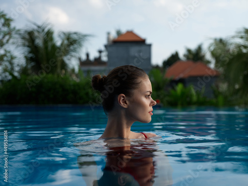 pretty woman in clear pool water and model cropped view