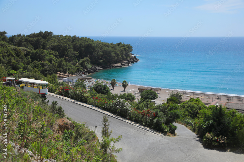 Picturesque view of sea beach near road and forest