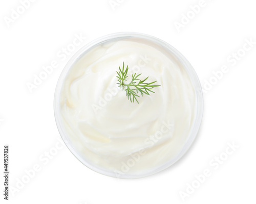 Delicious sour cream with dill in bowl on white background, top view
