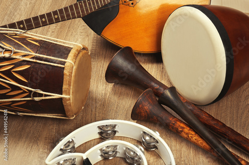 Set of different vintage musical instruments on wooden background, closeup