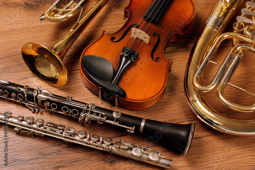 Set of different musical instruments on wooden background, closeup photo