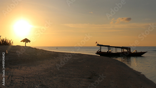 boat on a beach at sunset