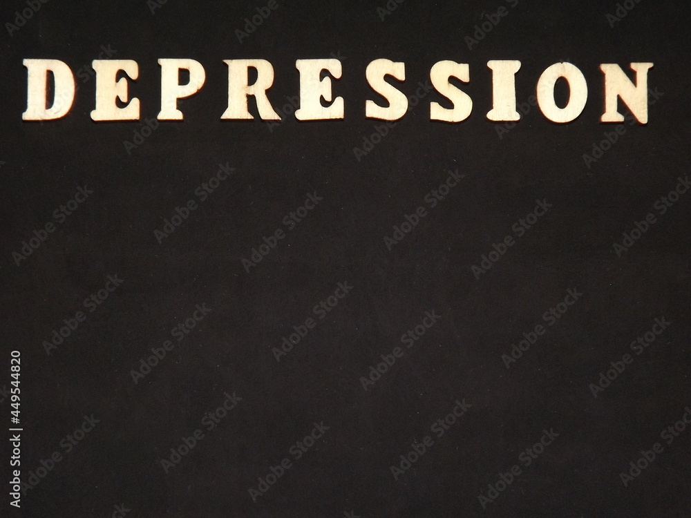 Fototapeta premium mental illness depression in wooden letters on a black background. High quality photo
