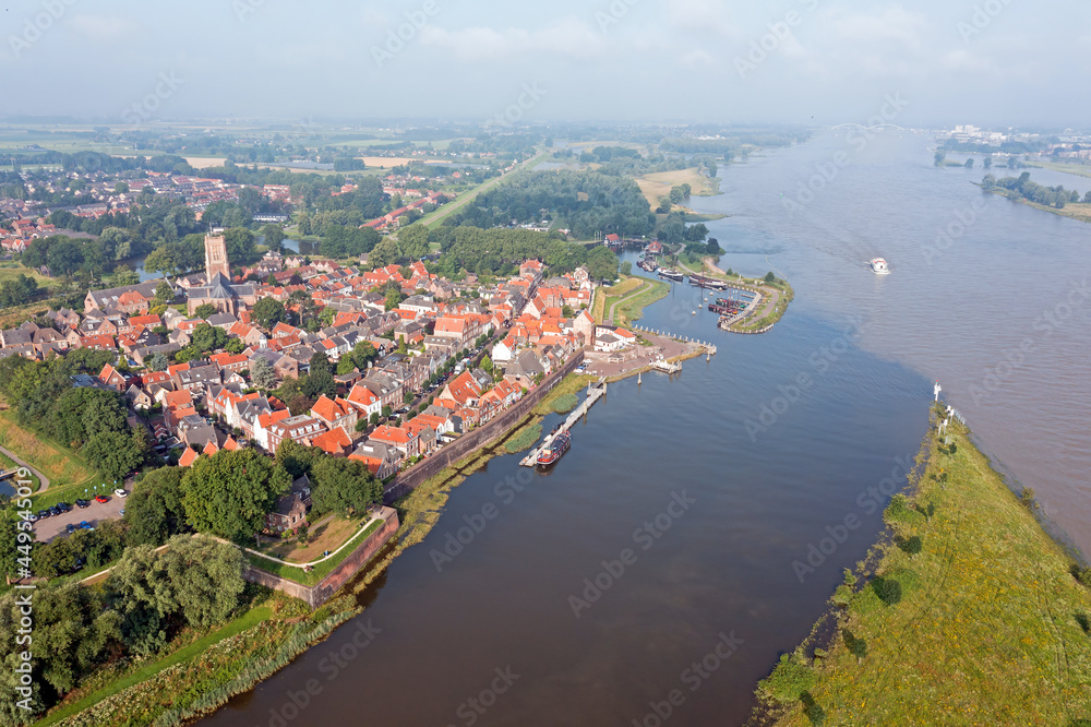 Fototapeta premium Aerial from the city Woudrichem at the river Merwede in the Netherlands in a flooded landscape