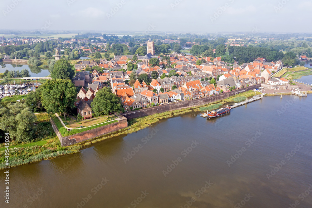Aerial from the city Woudrichem at the river Merwede in the Netherlands in a flooded landscape