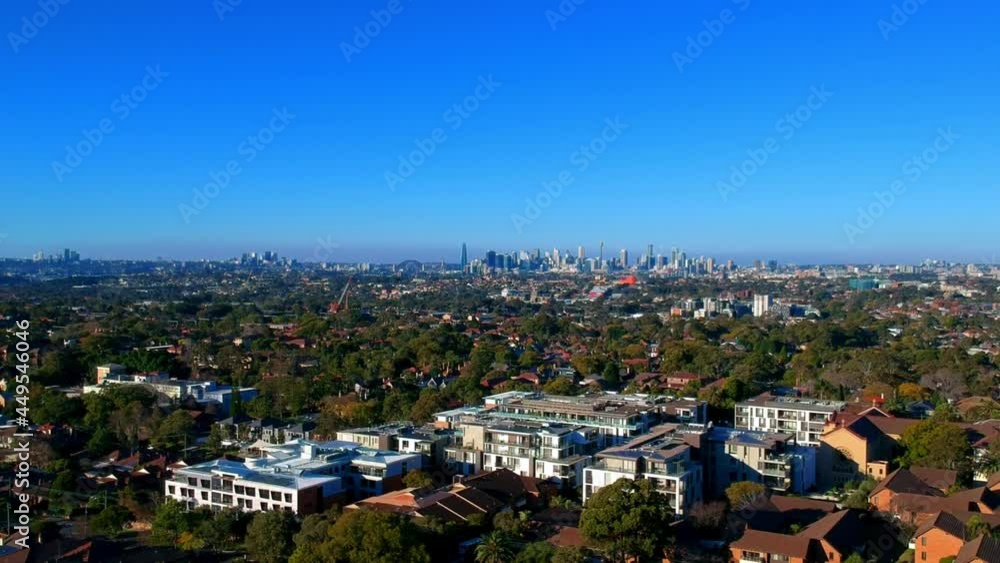 Panoramic Aerial Drone view of Suburban Sydney housing, roof tops, the streets and the parks and CBD Skyline NSW Australia