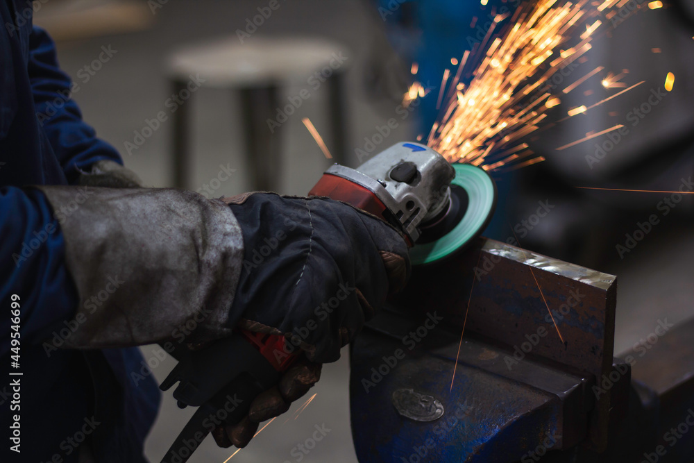 Fototapeta premium Metal workers use manual labor. Skilled welder.Technicians use steel cutting tools to cut steel. Metal cutting. The worker uses gas to cut steel. content work safety