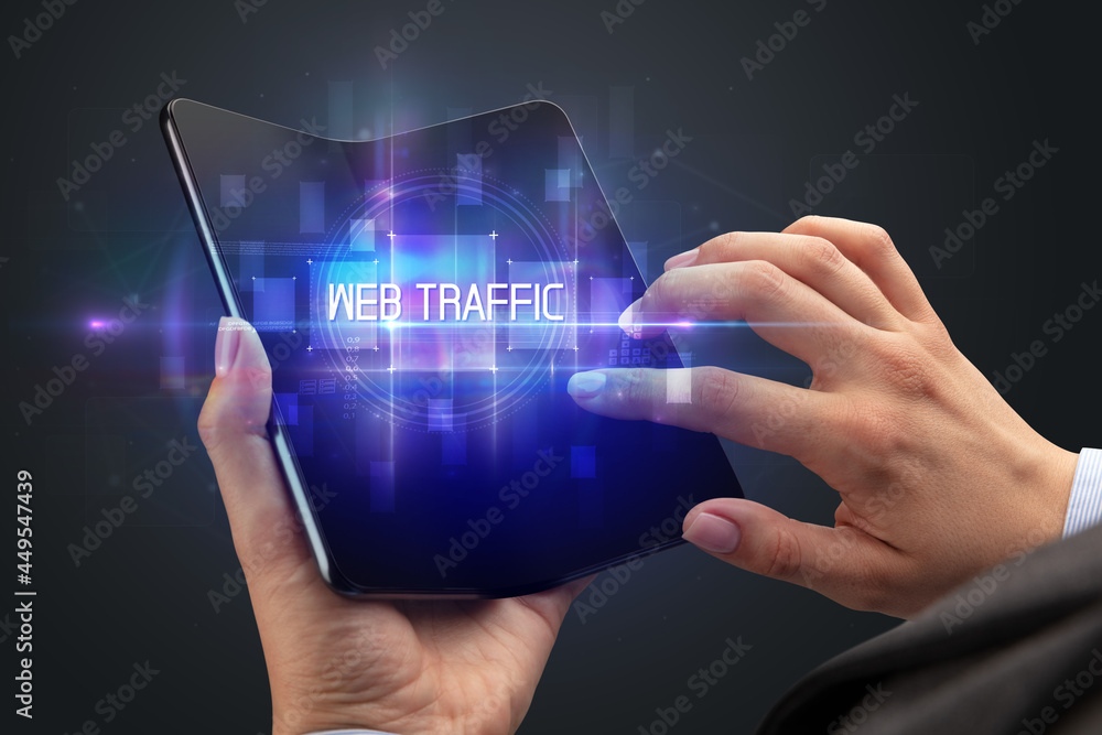 Businessman holding a foldable smartphone Businessman holding a foldable smartphone