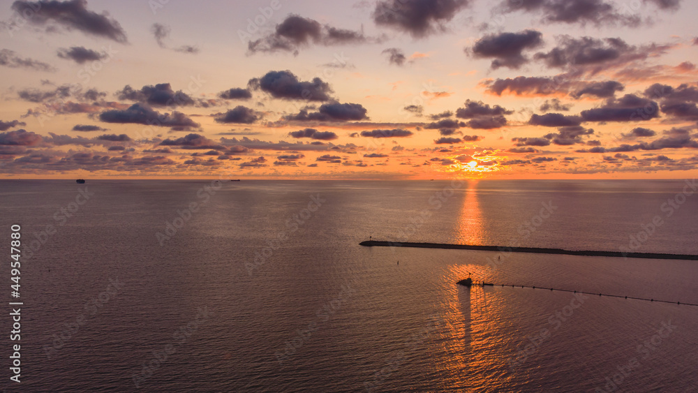 Obraz premium Sunrise in Gdańsk. View from a drone from the vicinity of Górki Zachodnie in Gdańsk. Lighthouse and the Vistula River estuary to the sea.
