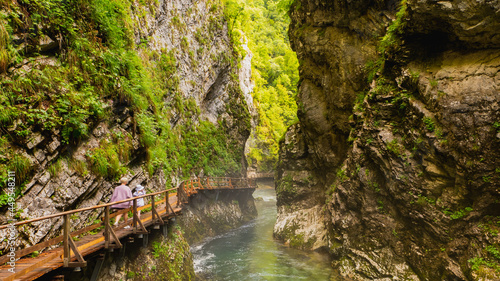 Vintgar gorge  Slovenia. River near the Bled lake with wooden tourist paths  bridges above river and waterfalls. Hiking in the Triglav national park. Fresh nature  blue water in the forest.