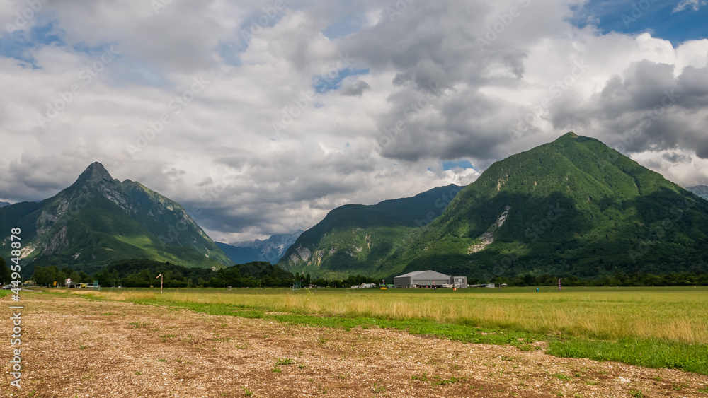 Dreamlike landscape in Slovenia, Julian Alps and a small sports airport. Dreamlike landscape in Slovenia, Julian Alps and a small sports airport.