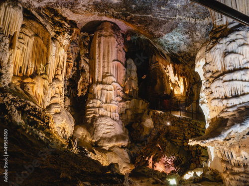 Quadro su tela Wonderful picture of passage for tourists in big cavern with huge stalactites, stalagmites and stalagnates in Postojna cave, Slovenia, Europe