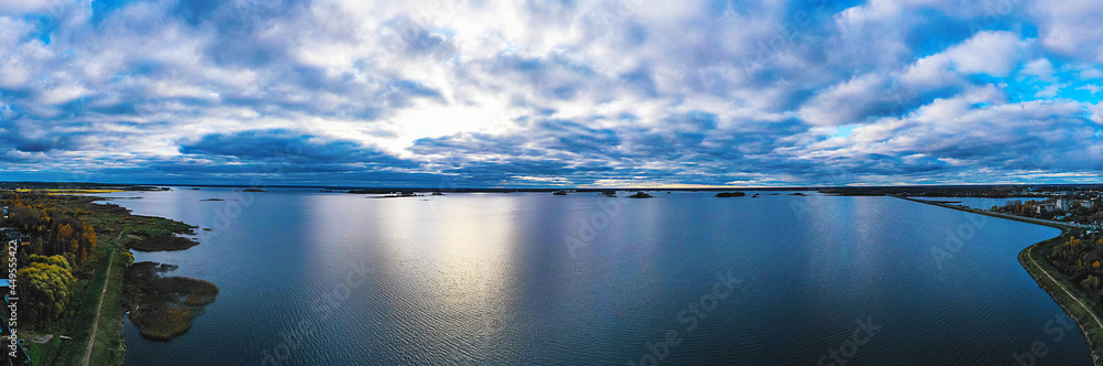 The Clouds over the lake panorama aerial. Evening landscape aerial. Aerial panorama. Clouds on the river in the evening.