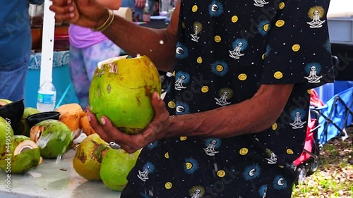 Street Vendor Cutting Coconut At the Farmers Market
 photo