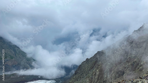 Fog in the mountains. Majestic beautiful mountains, rocks, glacier. Climbing Kazbek from the north, from Russia.