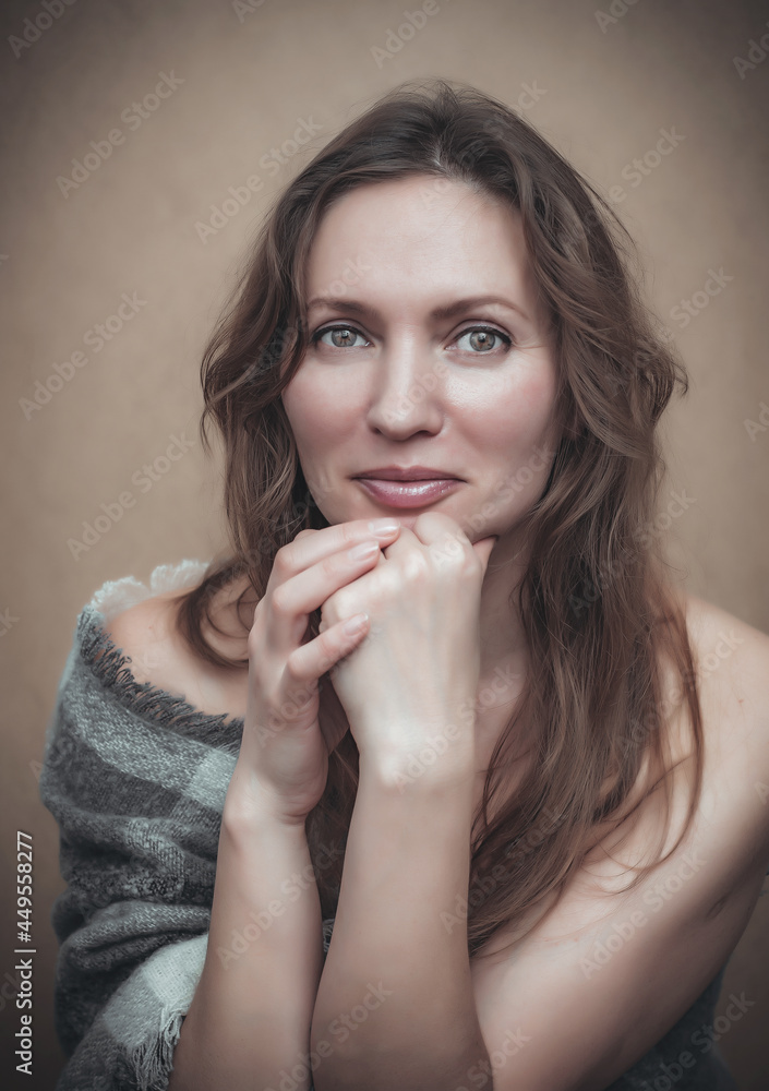 Portrait of a beautiful nude woman wrapped in a checkered plaid. Portrait of a beautiful nude woman wrapped in a checkered plaid.