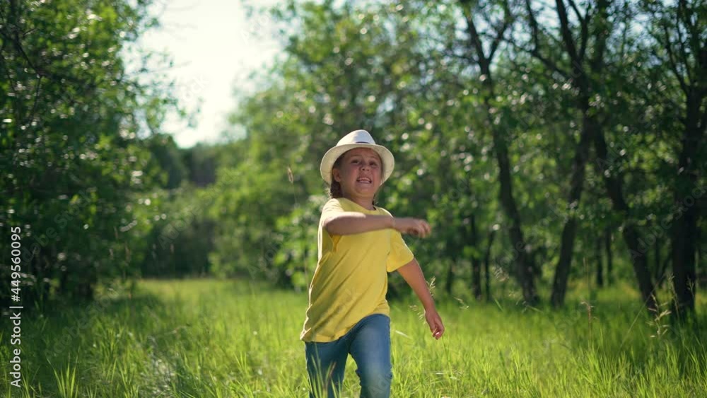 Happy girl. Little girl run through forest park. Kid plays on green grass. Happy kid run in garden. Green grass and trees in forest park. Little girl run through green garden.Happy girl among trees Happy girl. Little girl run through forest park. Kid plays on green grass. Happy kid run in garden. Green grass and trees in forest park. Little girl run through green garden.Happy girl among trees