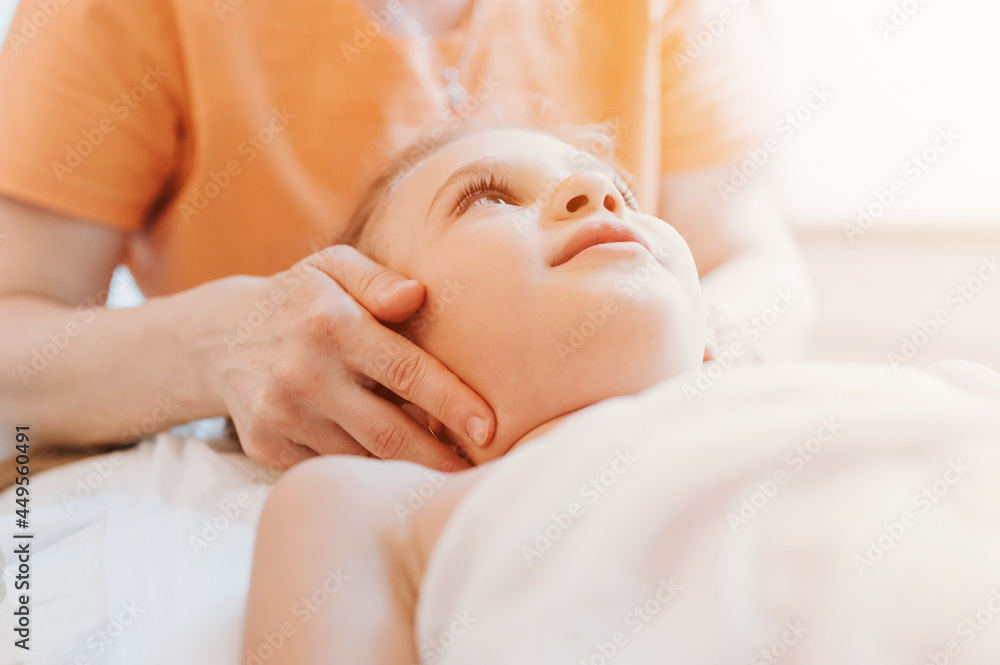 real doctor osteopath hands does physiological and emotional therapy for eight year old kid girl. pediatric osteopathy treatment session. alternative medicine. taking care of the child's health. flare real doctor osteopath hands does physiological and emotional therapy for eight year old kid girl. pediatric osteopathy treatment session. alternative medicine. taking care of the child's health. flare