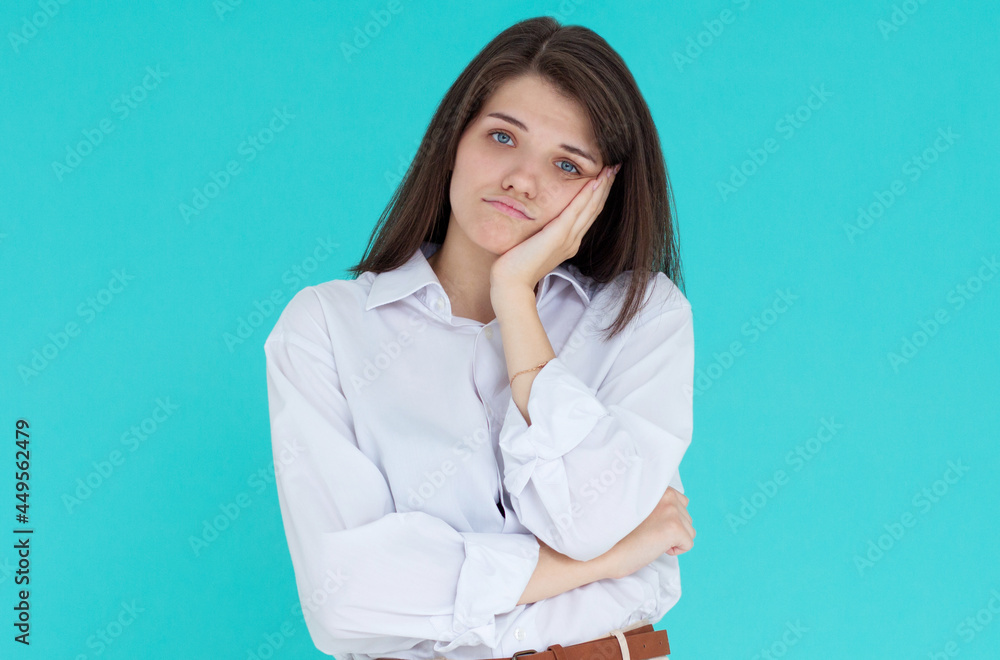 You waste my time on stupid talks. Bothered and bored cute european female model leaning face on palm while standing over blue wall with indifferent annoyed expression You waste my time on stupid talks. Bothered and bored cute european female model leaning face on palm while standing over blue wall with indifferent annoyed expression