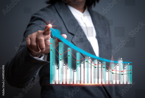 Business woman hand touching Financial charts show increased income on the touch screen, creative idea presentation technology drawing graph inspiration growth investment marketing concept.