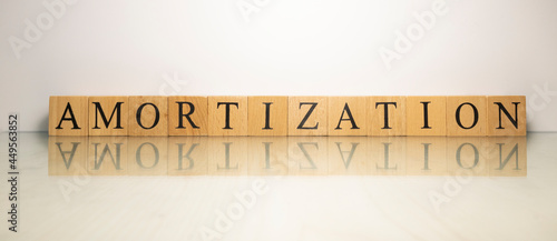 The name Amortization was created from wooden letter cubes. finance and economy.