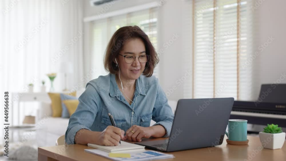 Asia adult people older lady remote distance work sit on desk at home smile happy watch SME owner live meeting class on MBA self tutor webcam webinar for reskill upskill job in web digital tablet.