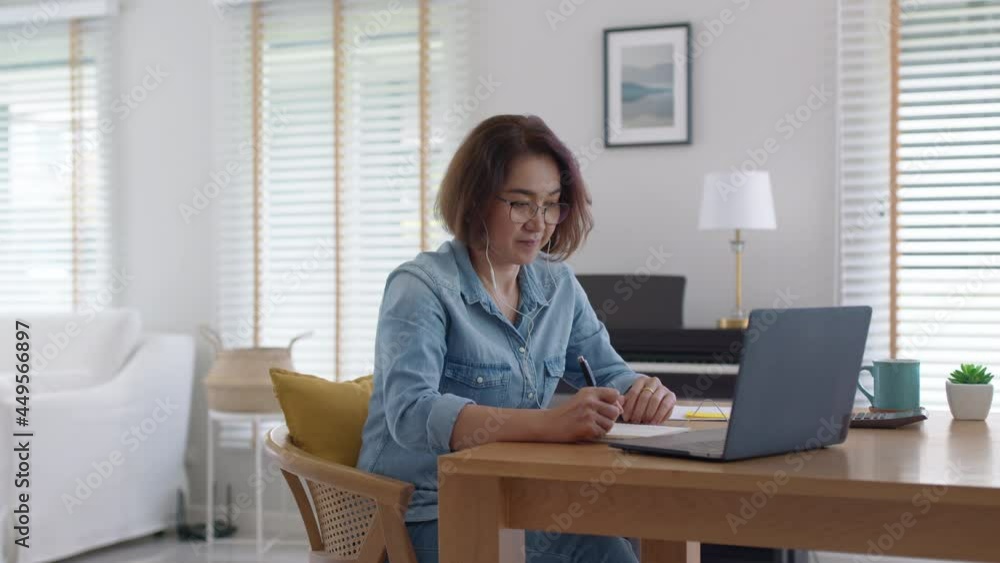 Asia adult people older lady remote distance work sit on desk at home smile happy watch SME owner live meeting class on MBA self tutor webcam webinar for reskill upskill job in web digital tablet. Asia adult people older lady remote distance work sit on desk at home smile happy watch SME owner live meeting class on MBA self tutor webcam webinar for reskill upskill job in web digital tablet.