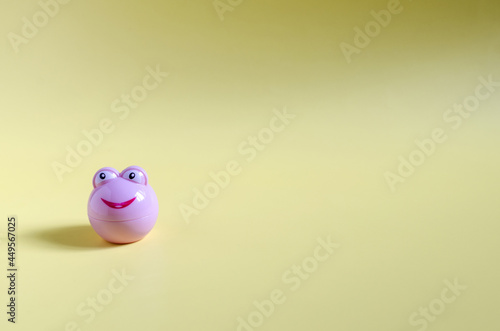 Wallpaper Mural A pink bottle of cosmetics with an animal face on a yellow background. Cosmetics on a light background of the copy space Torontodigital.ca