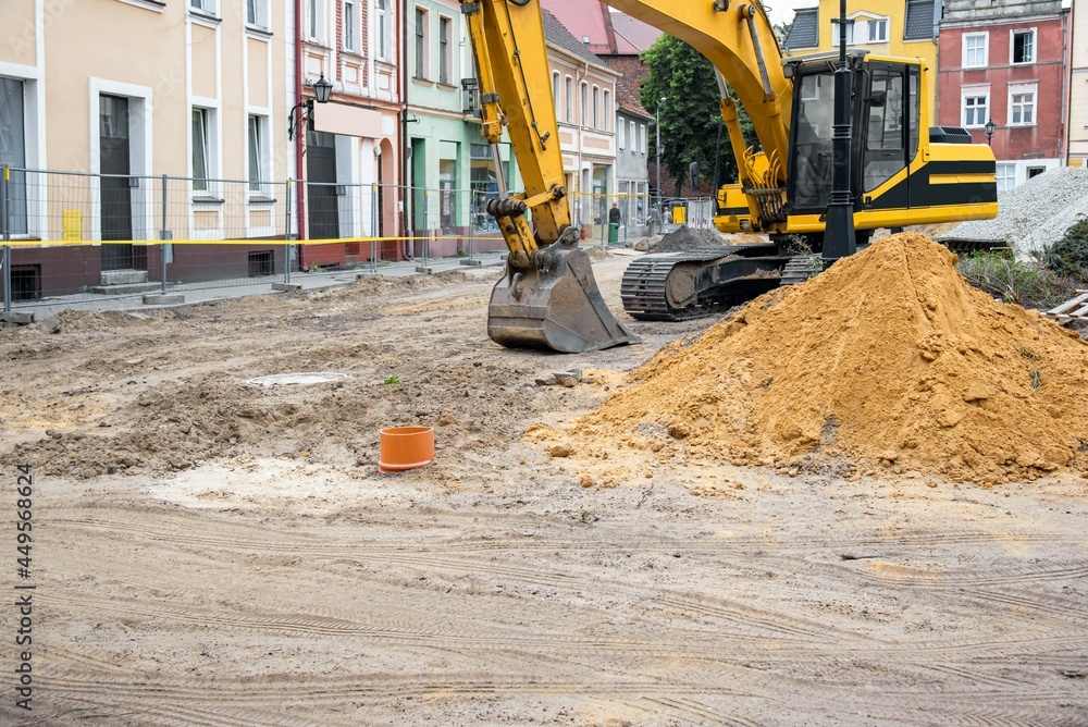 excavator on the construction square, reconstruction of the city