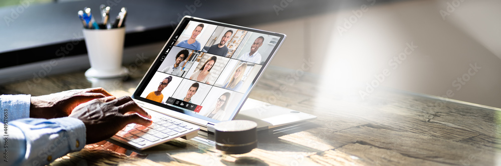 © Andrey Popov - African American Watching Video Conference Webinar © Andrey Popov - African American Watching Video Conference Webinar