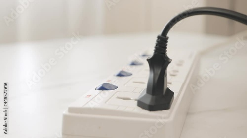 Wallpaper Mural Close up Male hand plugging in a power cord on the table. Torontodigital.ca