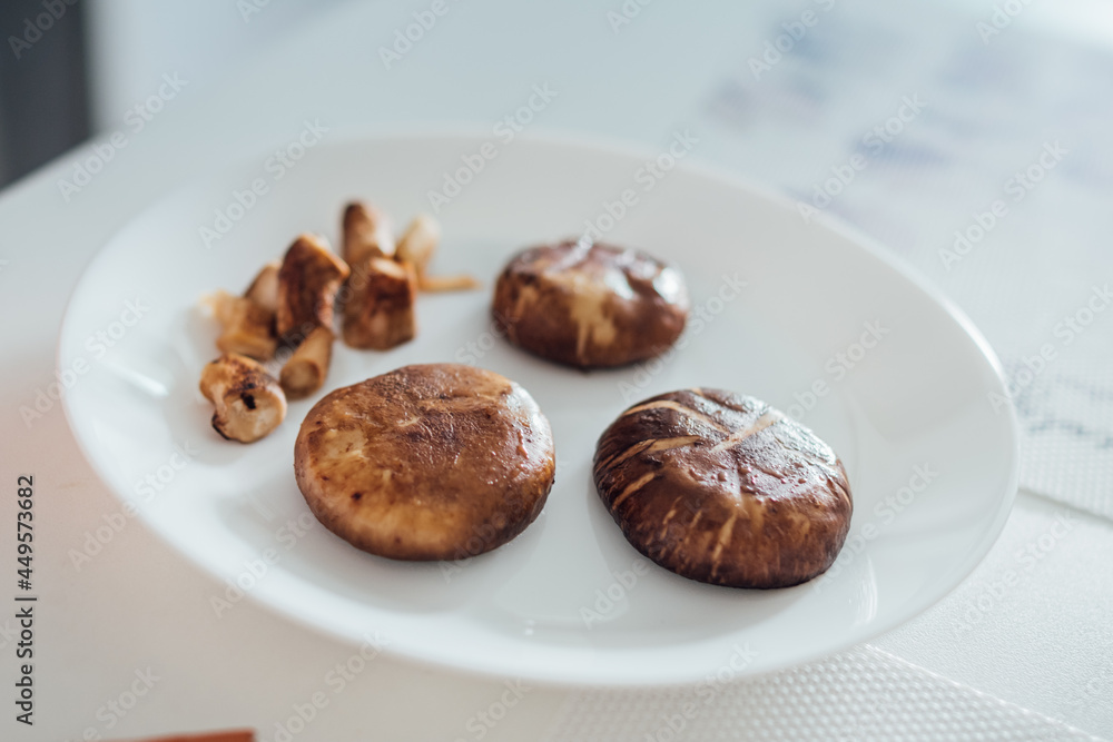grill brown mushroom on white plate for prepare the breakfast. grill brown mushroom on white plate for prepare the breakfast.