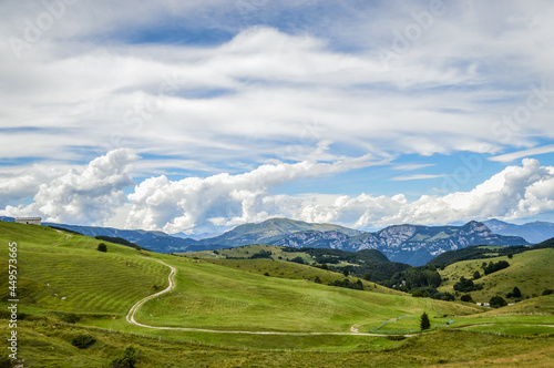 Fantastic landscape with path that climbs towards a hut seen from the Fittanze Di Sega Pass, in Lessinia, near Verona in Italy