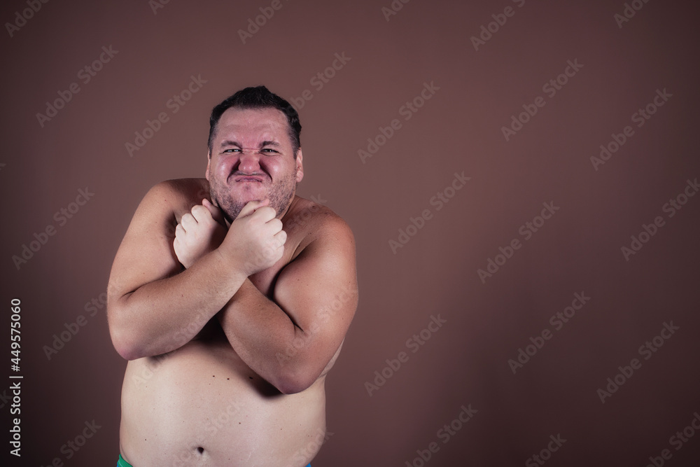 Fototapeta premium Sports and healthy lifestyle. Funny fat man goes in for sports.