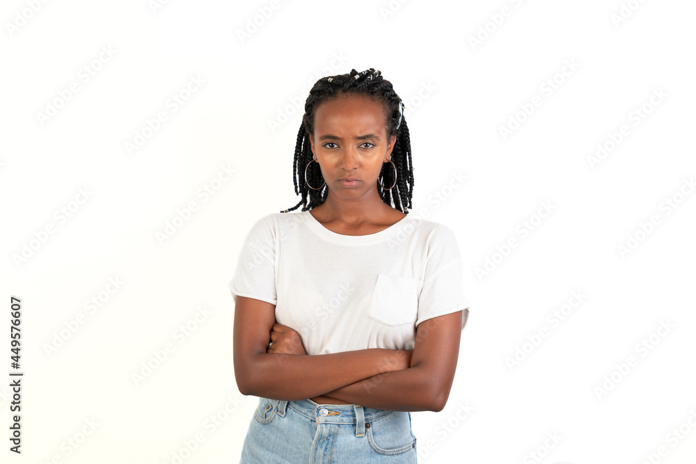 Angry woman with braids and the arms crossed. Looking at camera. White background. African-Ethiopian black woman. Angry woman with braids and the arms crossed. Looking at camera. White background. African-Ethiopian black woman.