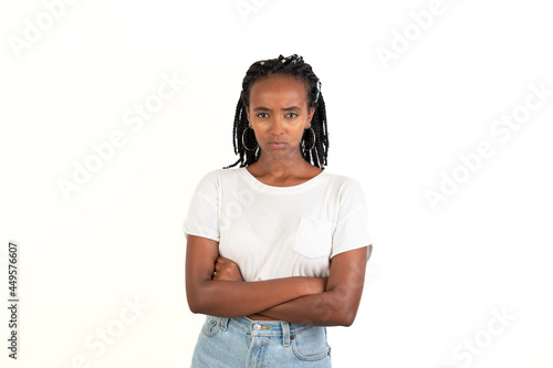 Angry woman with braids and the arms crossed. Looking at camera. White background. African-Ethiopian black woman.